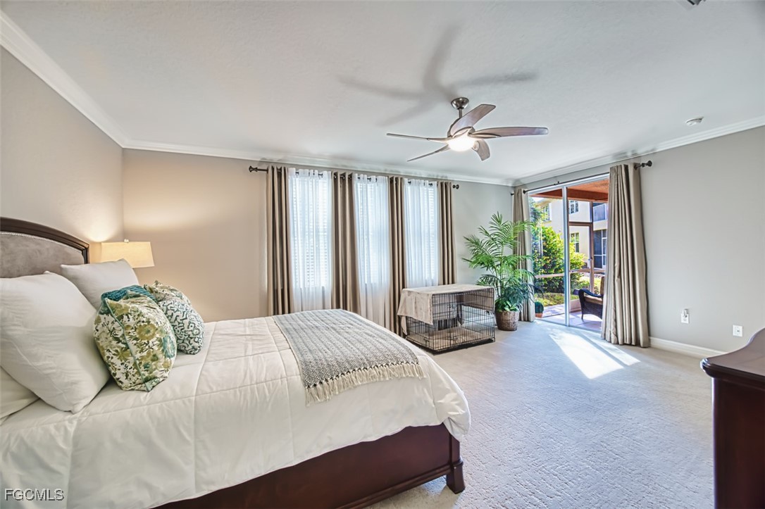 12129 Lucca Street, Unit 102 Fort Myers, FL 33966 - Photo 32 of 40 a spacious bedroom with a bed and a chandelier
