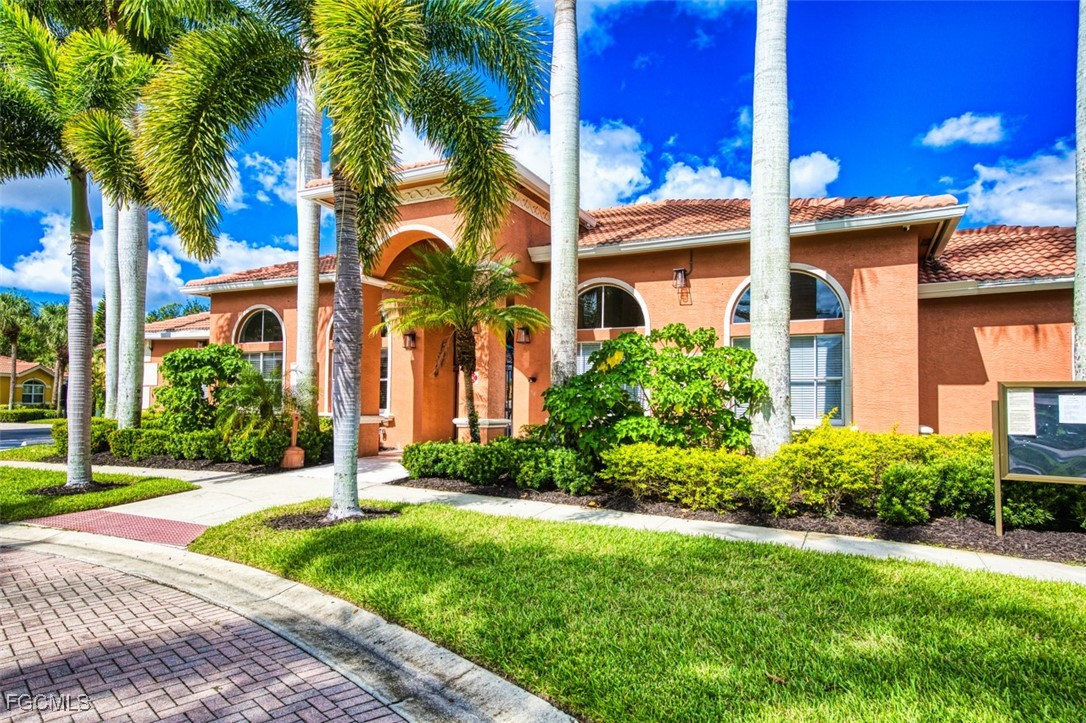 12129 Lucca Street, Unit 102 Fort Myers, FL 33966 - Photo 34 of 40 a front view of a house with a garden
