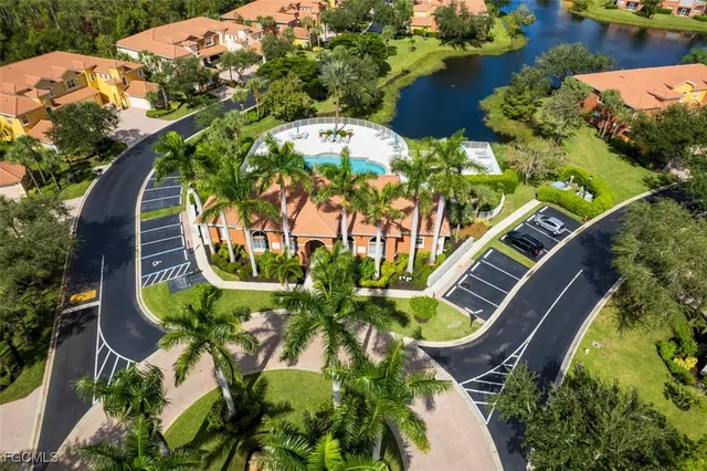 an aerial view of a residential houses with yard