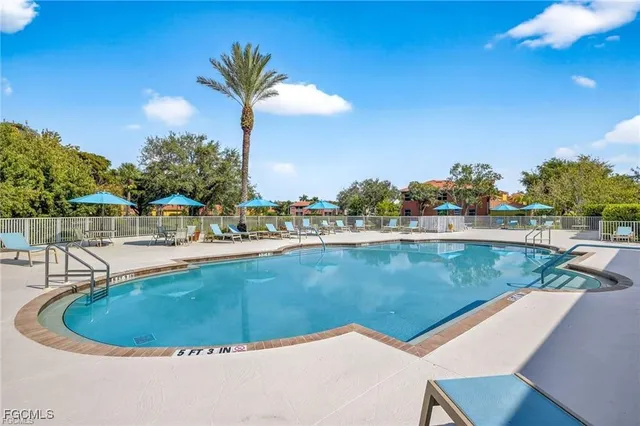a view of a swimming pool with a lawn chairs