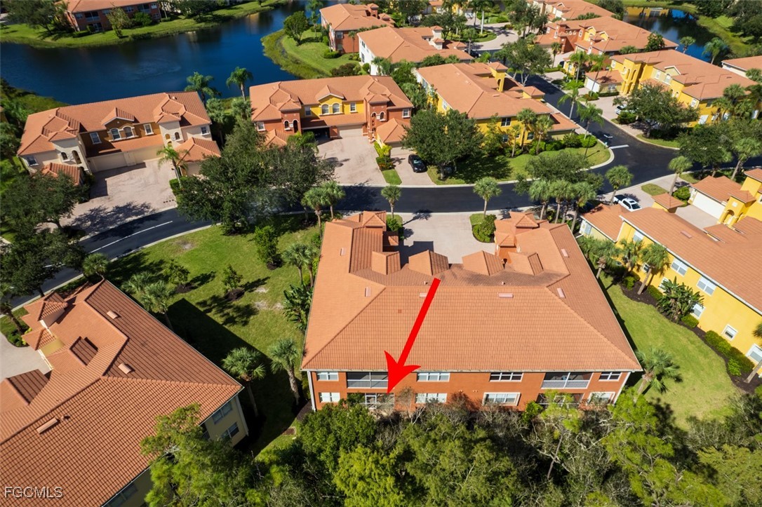 12129 Lucca Street, Unit 102 Fort Myers, FL 33966 - Photo 39 of 40 an aerial view of a house with a yard and lake view