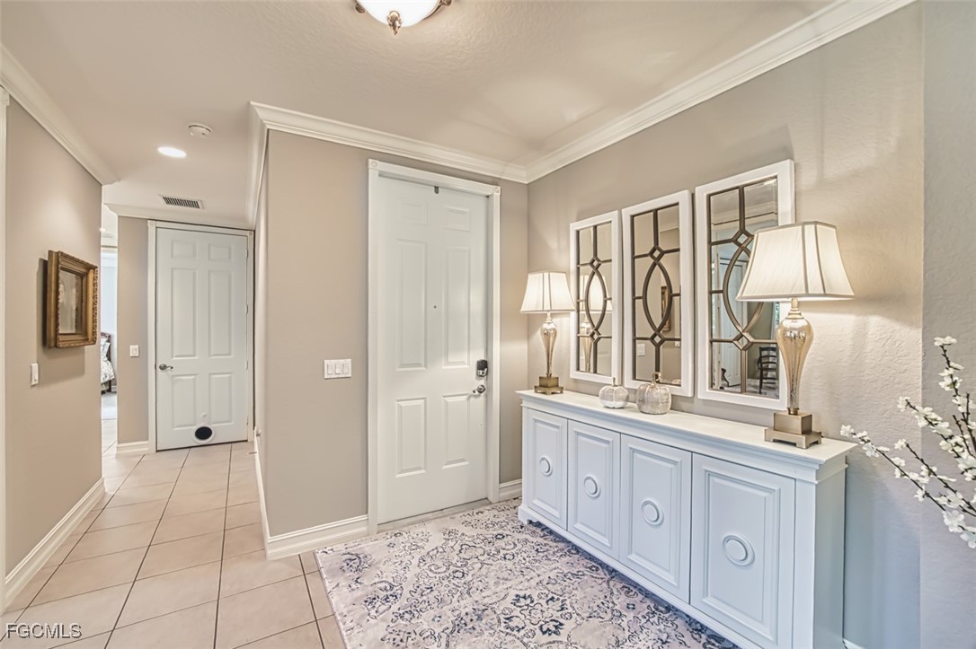 12129 Lucca Street, Unit 102 Fort Myers, FL 33966 - Photo 4 of 40 a spacious bathroom with a double vanity sink a mirror and a shower