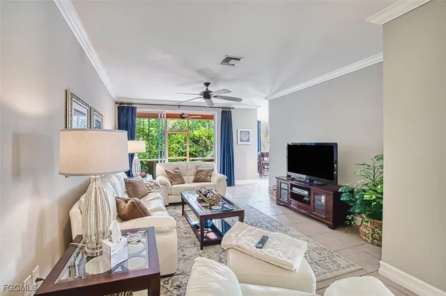 a living room with furniture a flat screen tv and a large window