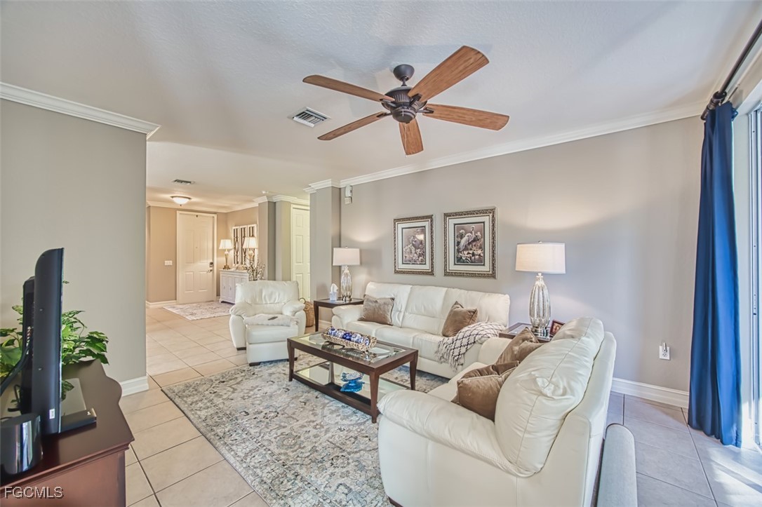 12129 Lucca Street, Unit 102 Fort Myers, FL 33966 - Photo 7 of 40 a living room with furniture and a wooden floor