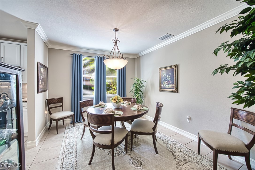 12129 Lucca Street, Unit 102 Fort Myers, FL 33966 - Photo 8 of 40 a view of a dining room with furniture window and outside view