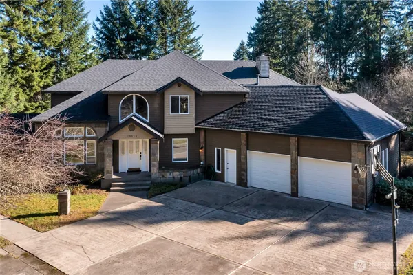 a front view of a house with a yard garage and outdoor seating