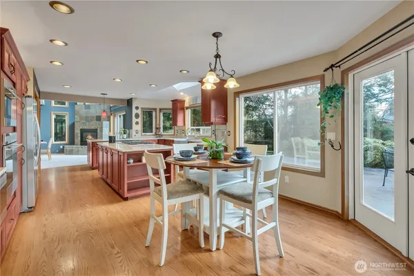 a view of a dining room with furniture large windows and wooden floor