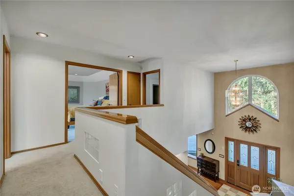 a bed sitting in a spacious bedroom next to a window