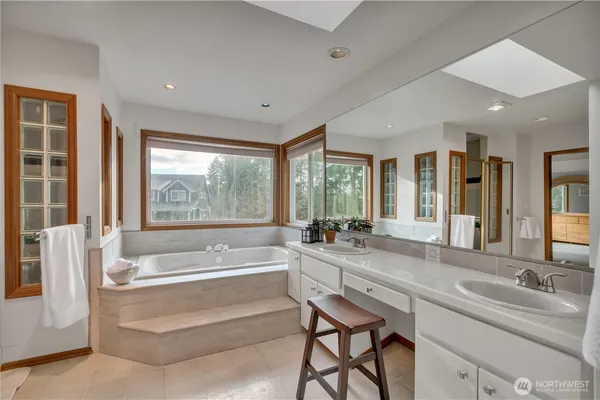 a bathroom with a tub shower and sink