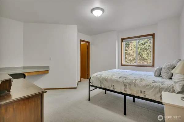 a room with a bed and a desk