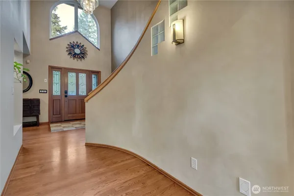 a view of entryway and hall with wooden floor