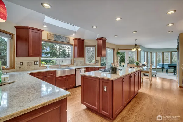 a kitchen with stainless steel appliances granite countertop a stove and a sink