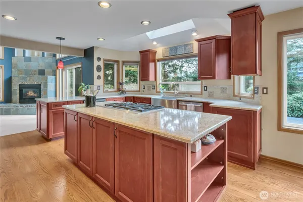 a kitchen with stainless steel appliances granite countertop a sink and a stove