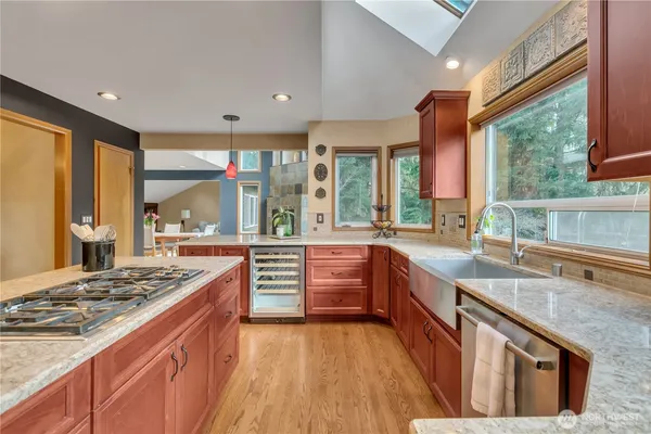 a kitchen with stainless steel appliances granite countertop a stove and a sink