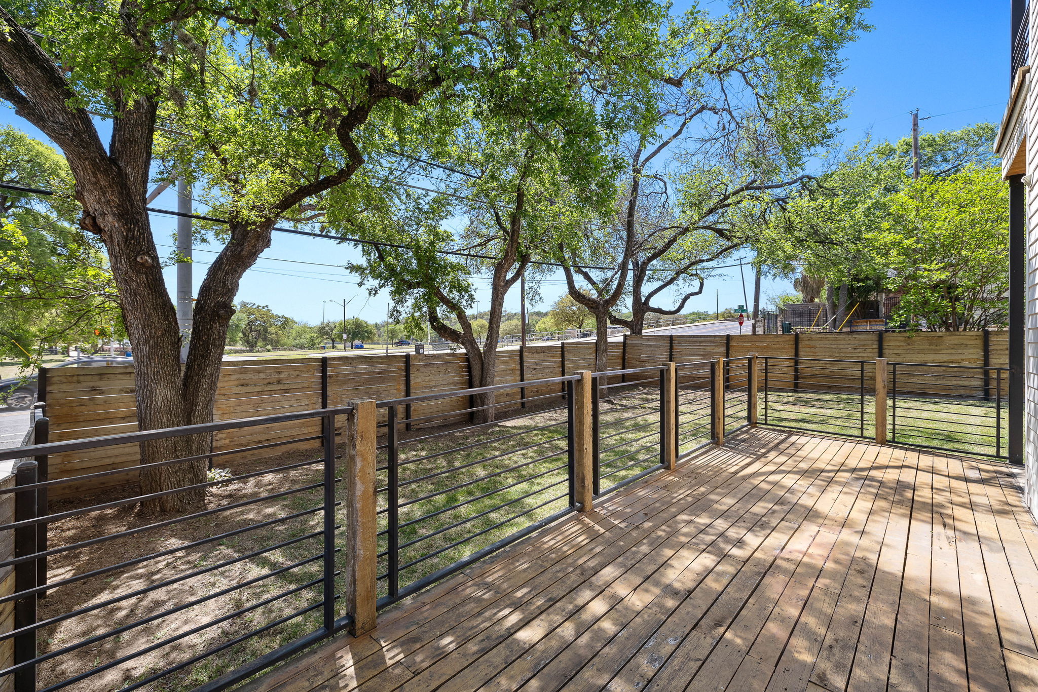 1201 Luna Street Austin, TX 78721 - Photo 9 of 31 a view of backyard with wooden fence and large trees