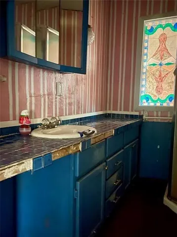 a kitchen with a sink cabinets and window