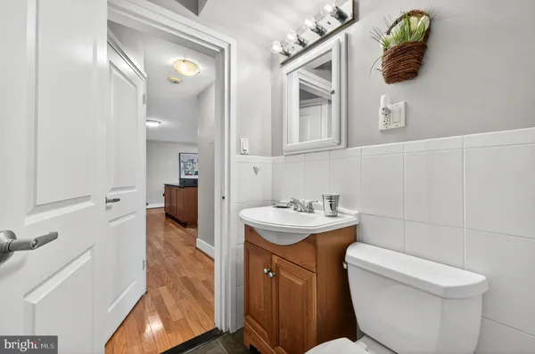 a bathroom with a toilet sink and mirror