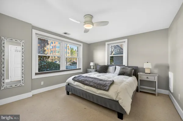 a bed room with a bed and a large window