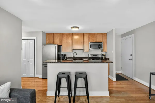 a kitchen with stainless steel appliances granite countertop a stove a refrigerator and a microwave