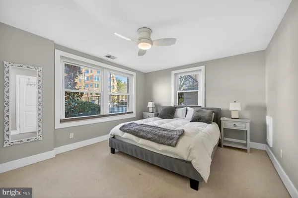 a spacious bedroom with a bed and a large window