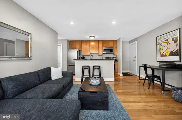a living room with furniture and a wooden floor