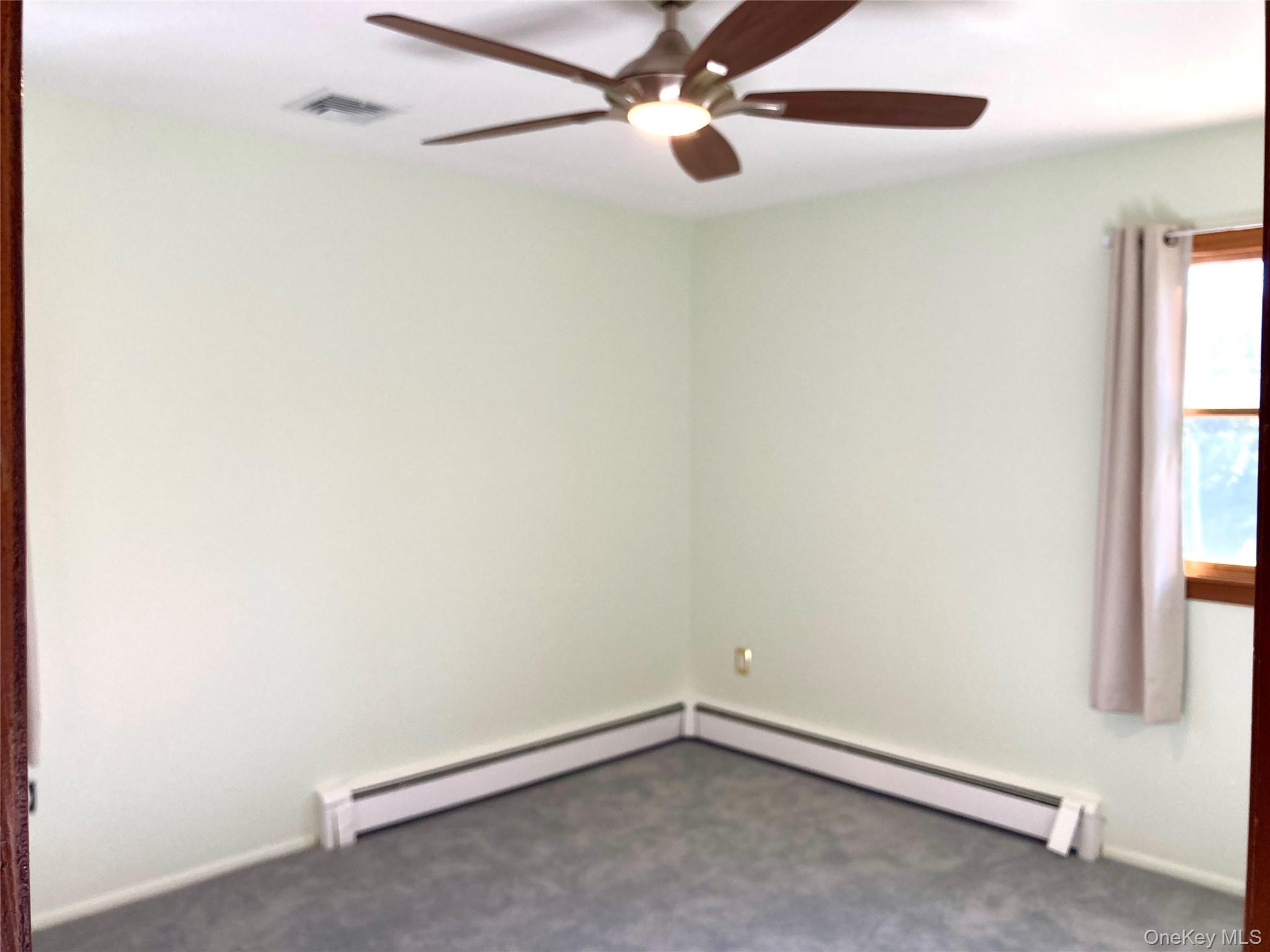 12 Soundview Avenue, Unit UPPR Oyster Bay, NY 11771 - Photo 13 of 20 an empty room with a window