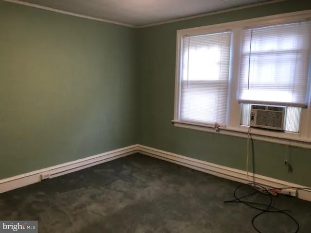 a room with a window and a ceiling fan