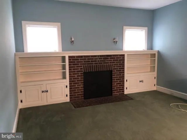 an empty room with a fireplace and painted walls