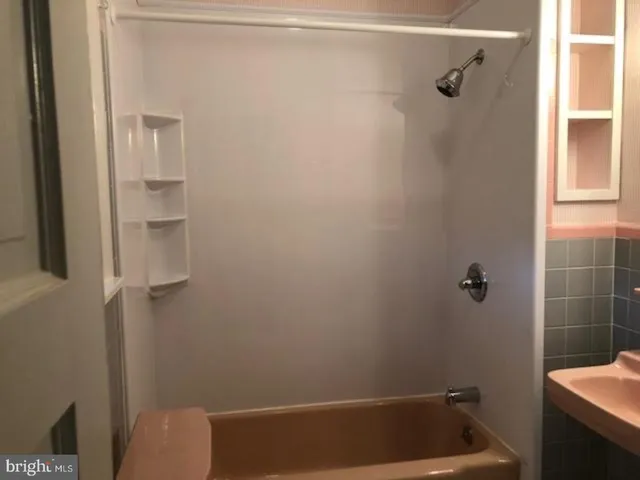 a bathroom with a shower and toilet