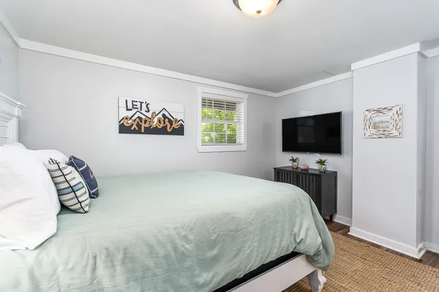 a bedroom with a bed and a flat screen tv