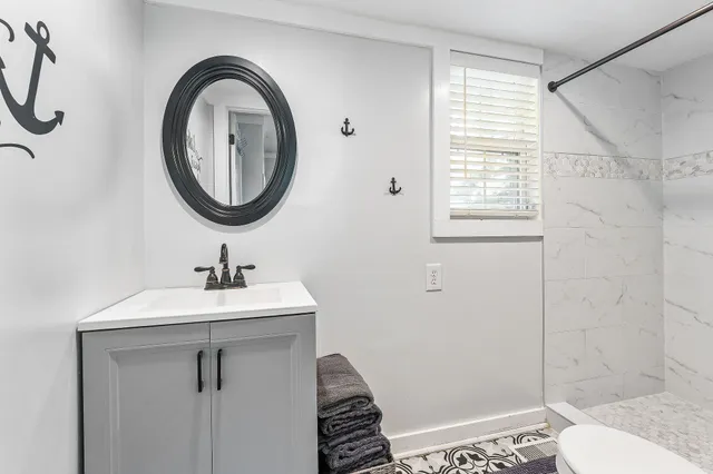 a bathroom with a sink a toilet and a shower