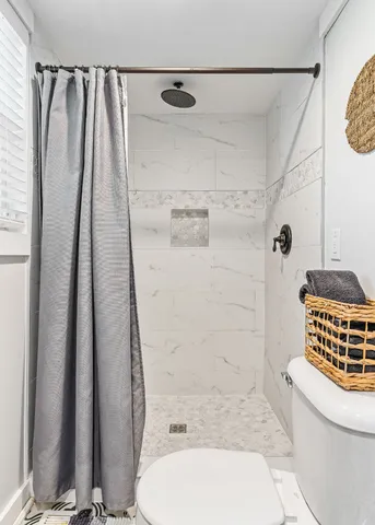 a bathroom with a shower and a toilet