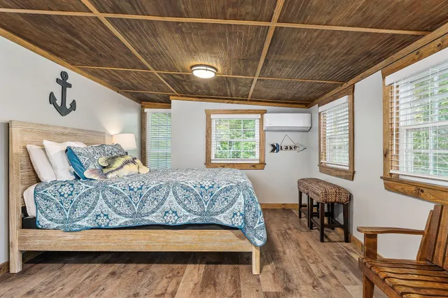 a bedroom with furniture and a large window