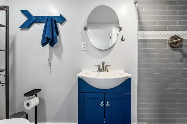 a bathroom with a sink a mirror and vanity