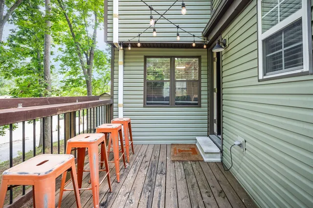 a view of a balcony with chairs and wooden floor
