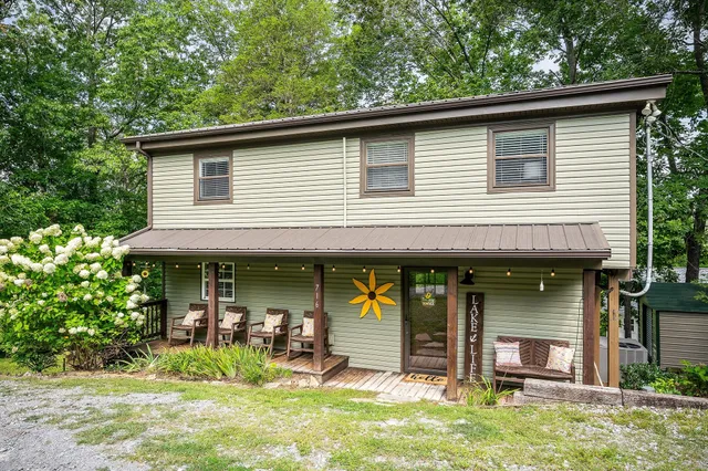 a view of a house with a porch and furniture