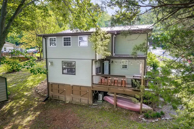 a view of flower garden with wooden fence