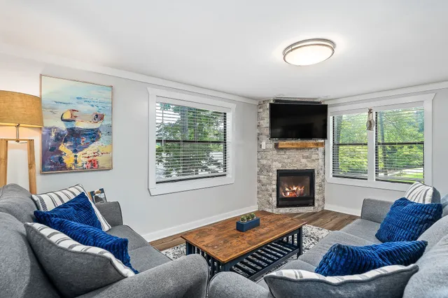 a living room with furniture flat screen tv and a fireplace