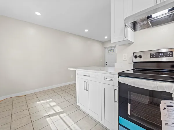 a kitchen with a stove cabinets and a sink