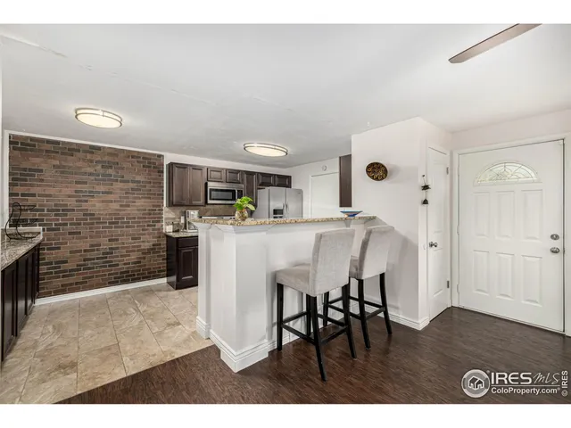 a kitchen with stainless steel appliances a refrigerator and a stove top oven