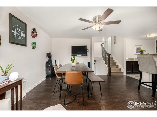 a view of a livingroom and dining room with furniture wooden floor