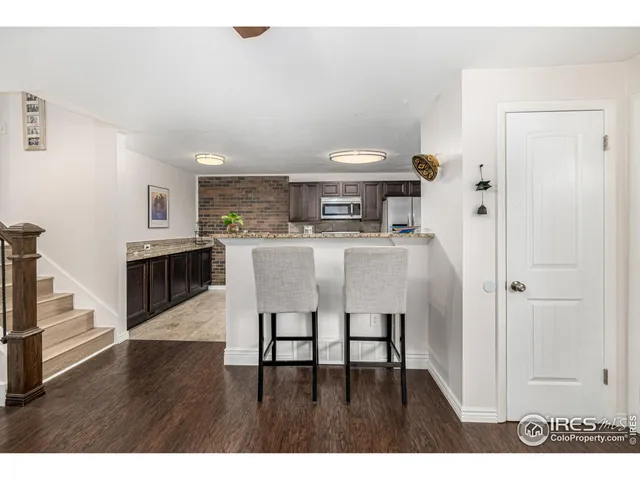 a kitchen with cabinets and wooden floor