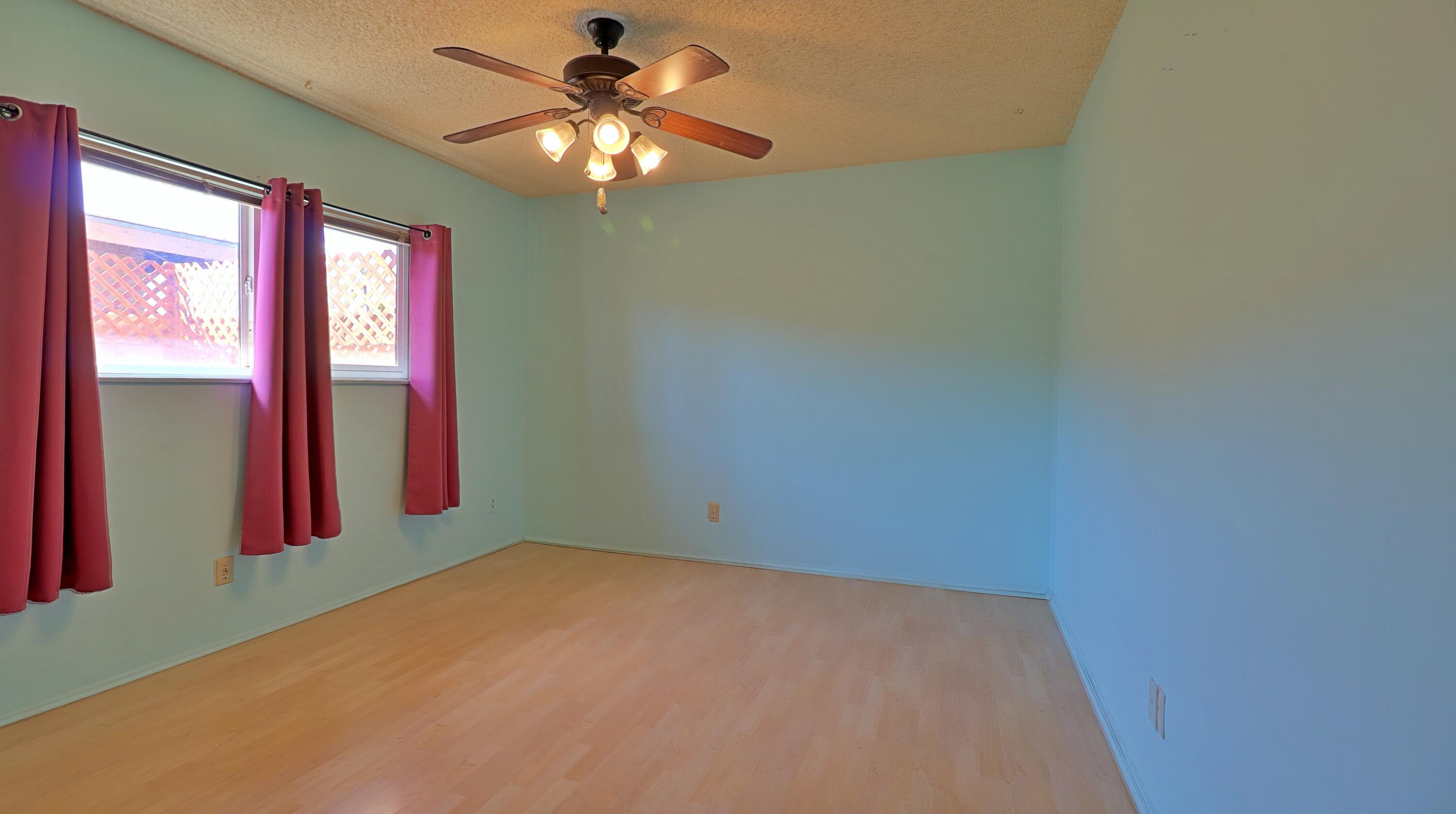 44840 Windsor Drive Indio, CA 92201 - Photo 11 of 26 an empty room with windows and fan