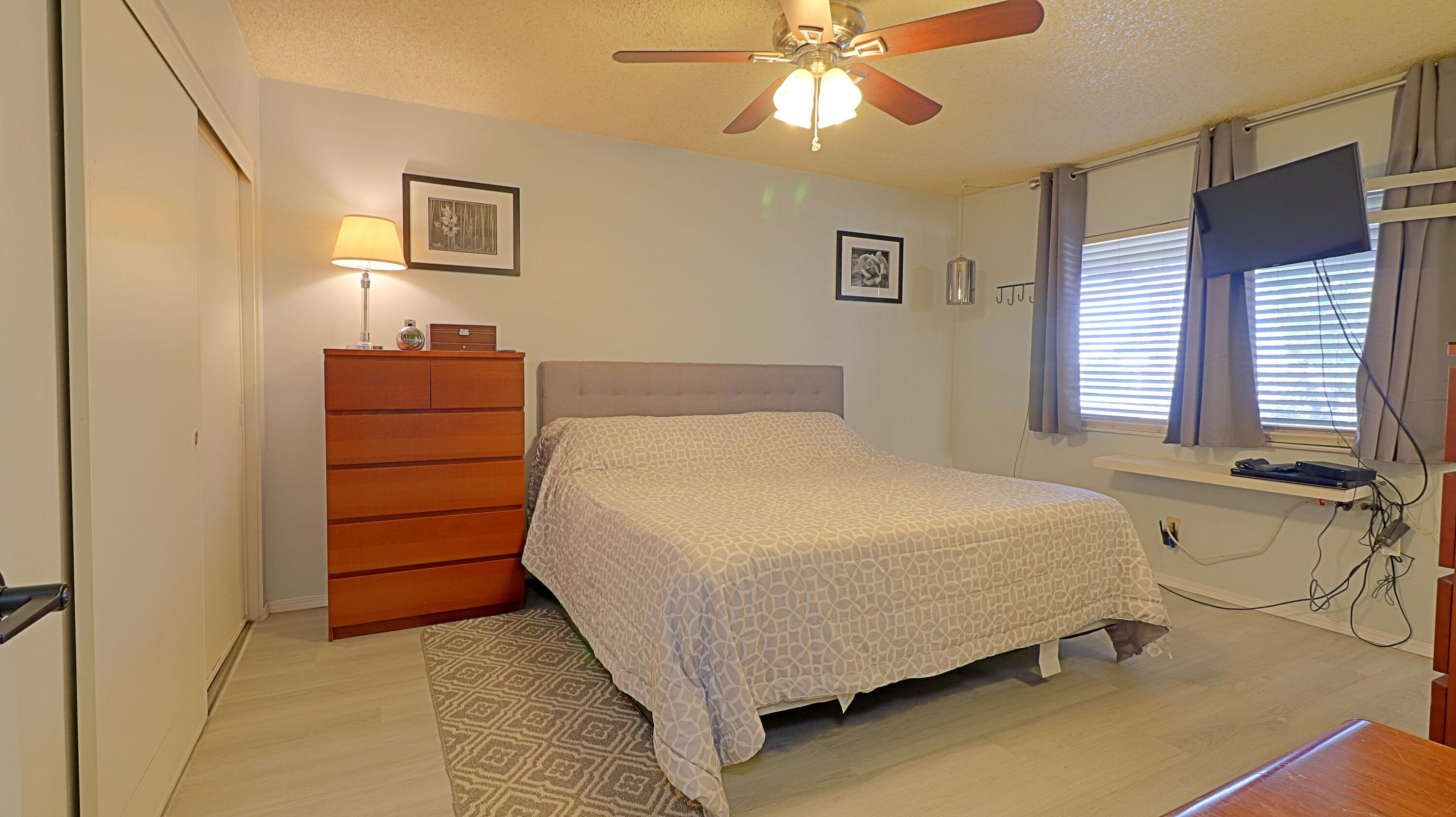 44840 Windsor Drive Indio, CA 92201 - Photo 12 of 26 a bedroom with a bed and a chandelier