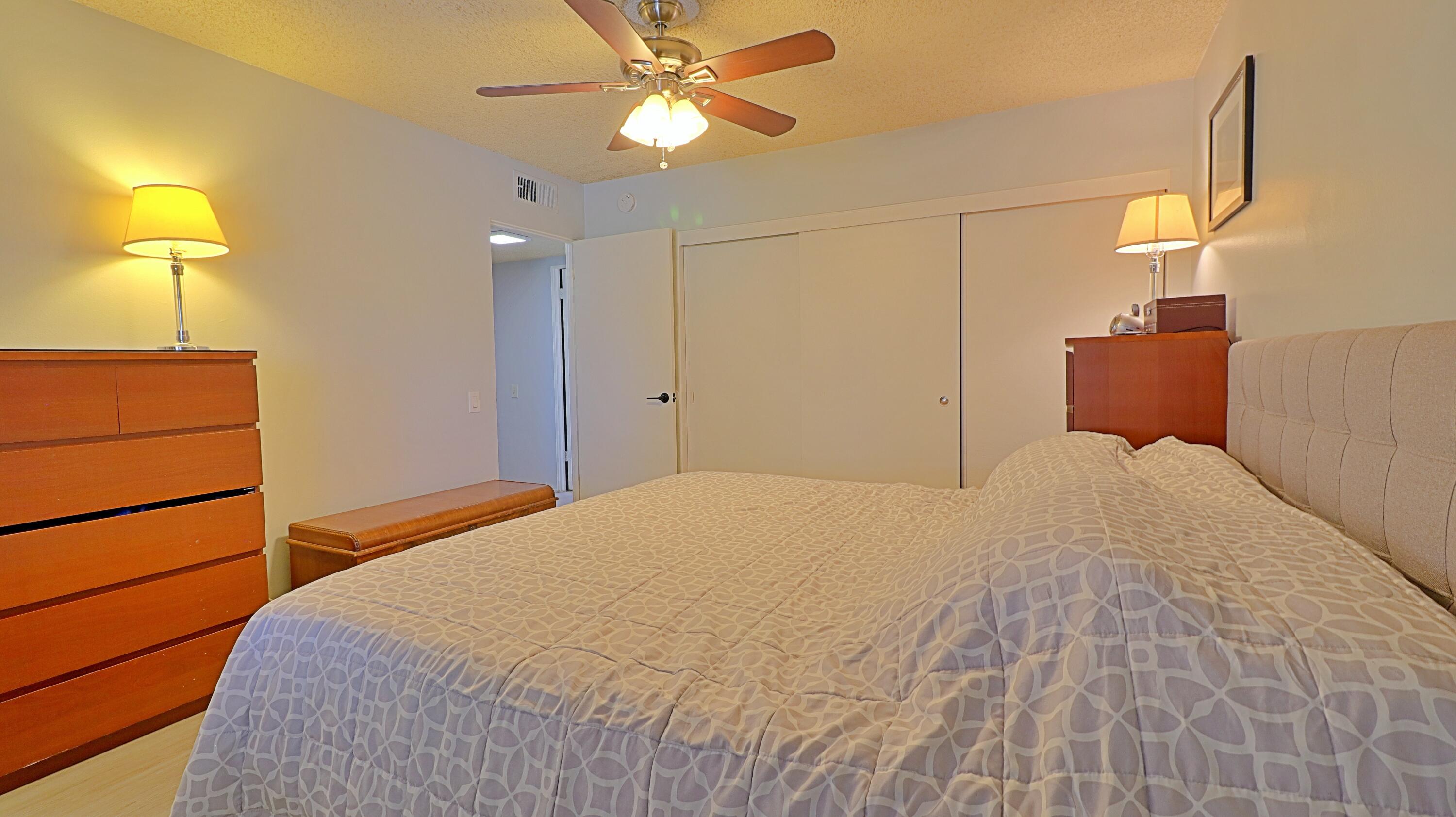 44840 Windsor Drive Indio, CA 92201 - Photo 13 of 26 a bedroom with a bed and a chandelier