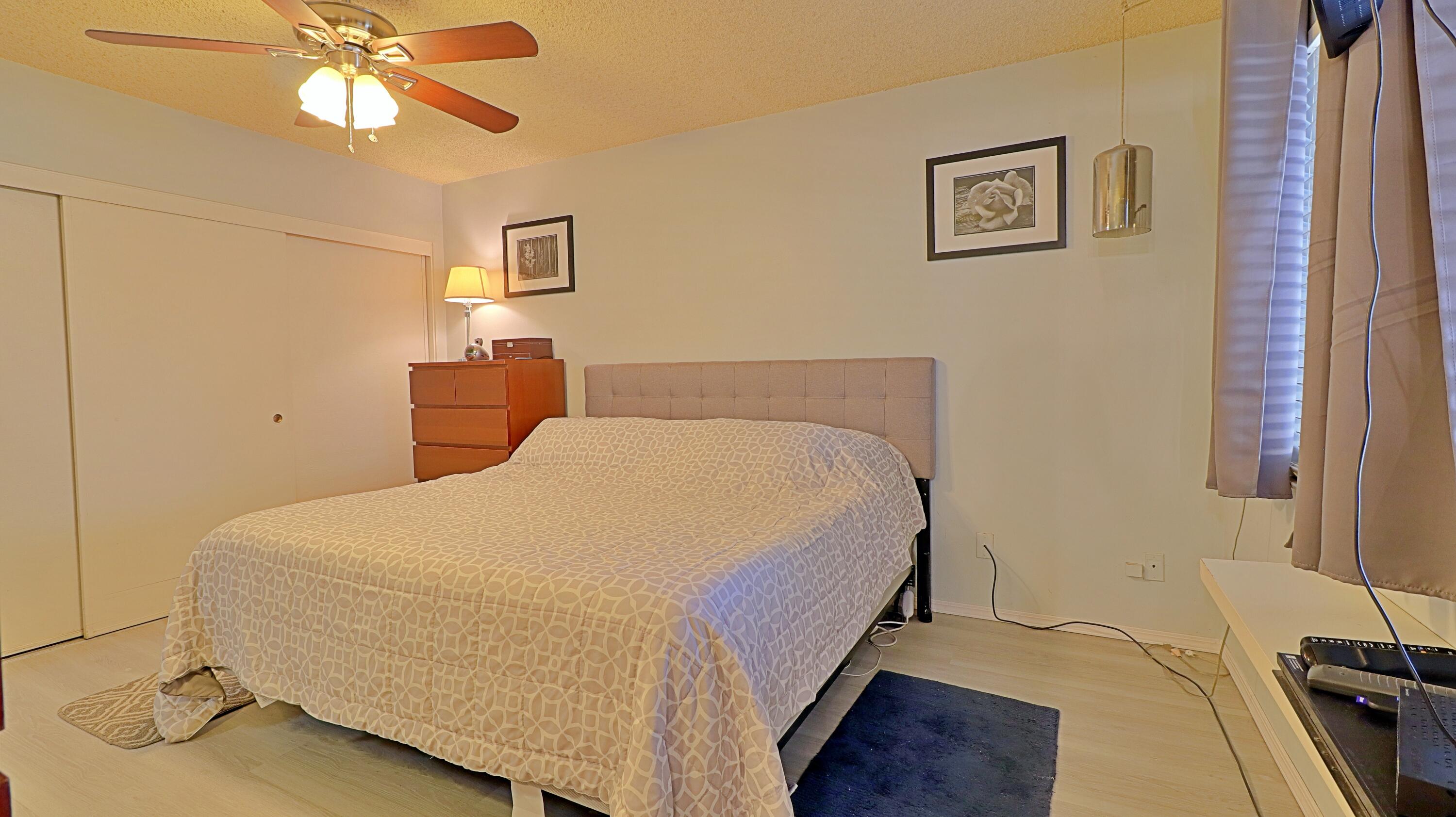 44840 Windsor Drive Indio, CA 92201 - Photo 16 of 26 a bedroom with a bed and a chandelier