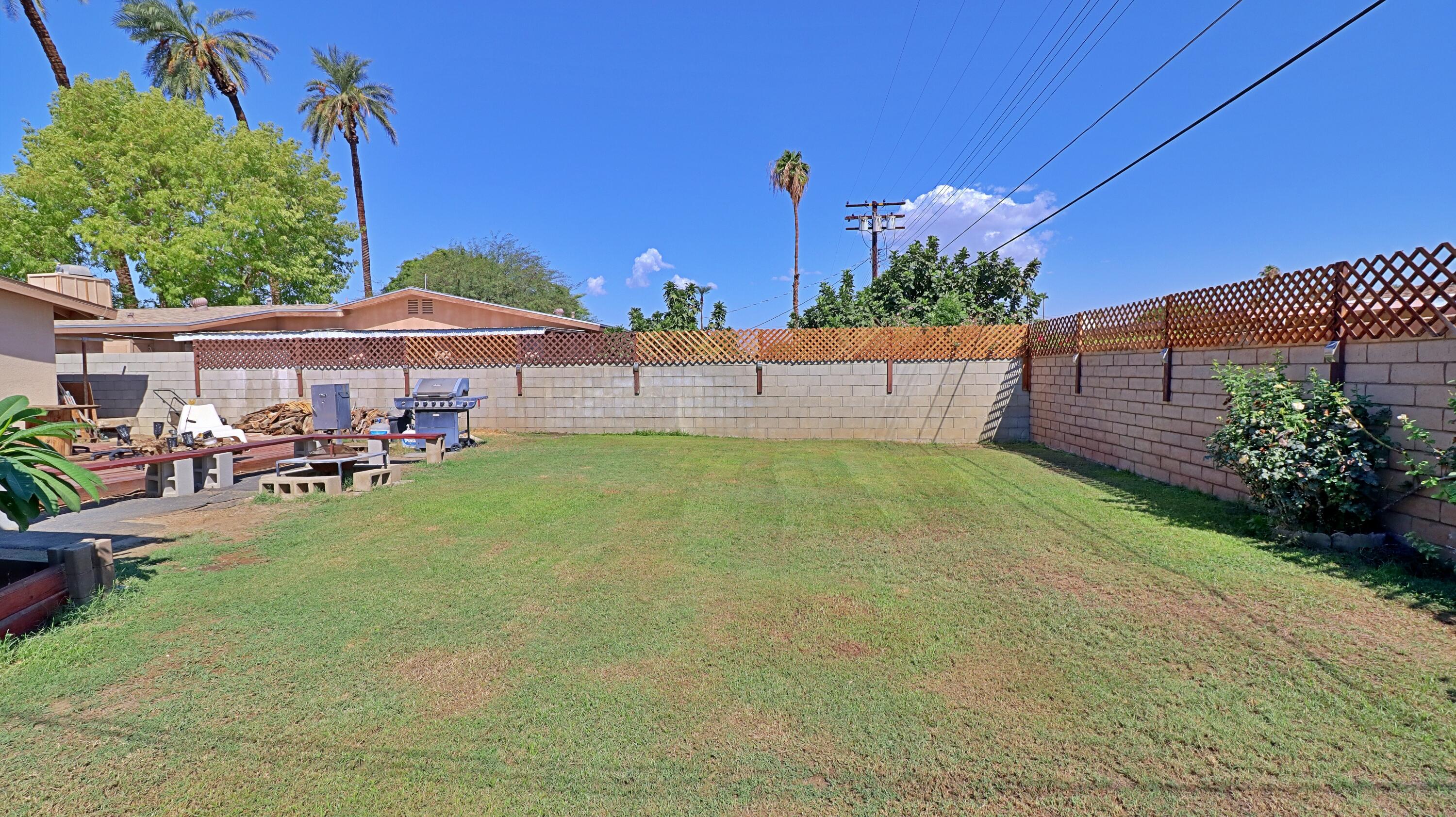 44840 Windsor Drive Indio, CA 92201 - Photo 19 of 26 a view of a patio with table and chairs under an umbrella