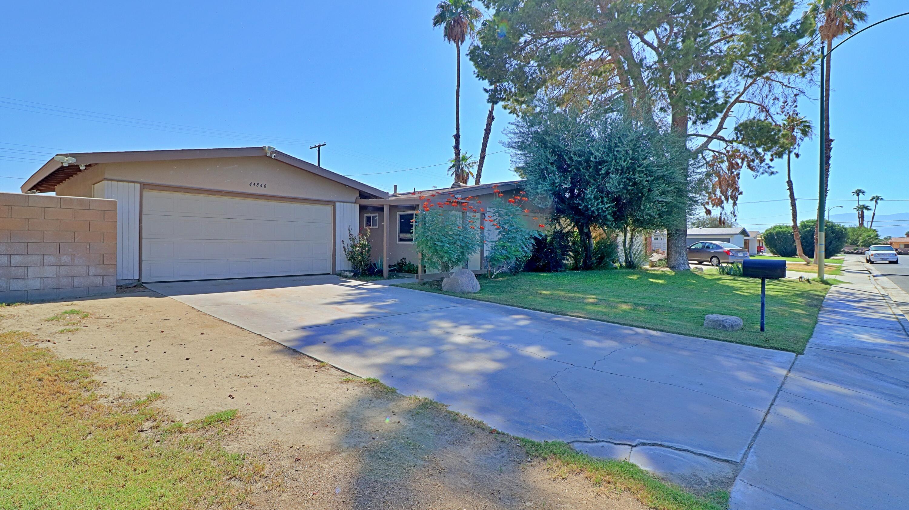 44840 Windsor Drive Indio, CA 92201 - Photo 25 of 26 a front view of a house with a yard and garage