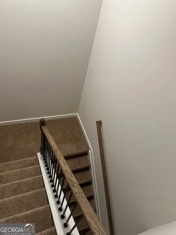 a bathroom with a granite countertop toilet a sink and a mirror