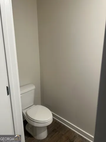 a white toilet sitting next to a shower